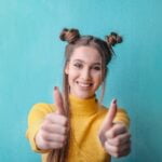woman in yellow turtleneck sweater smiling